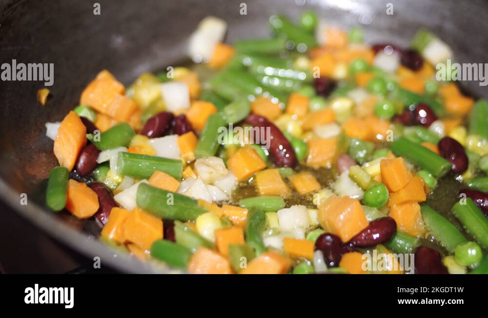 Frozen vegetable mixture is fried in boiling oil. Frying vegetables in