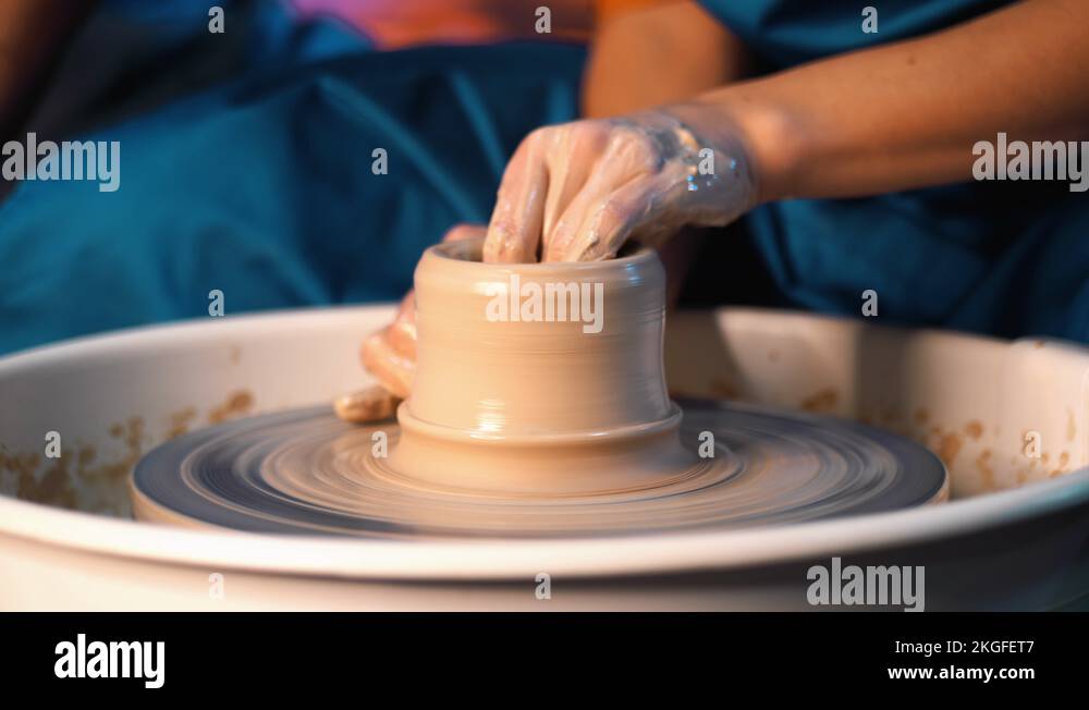Traditional pottery making, man teacher shows the basics of pottery in