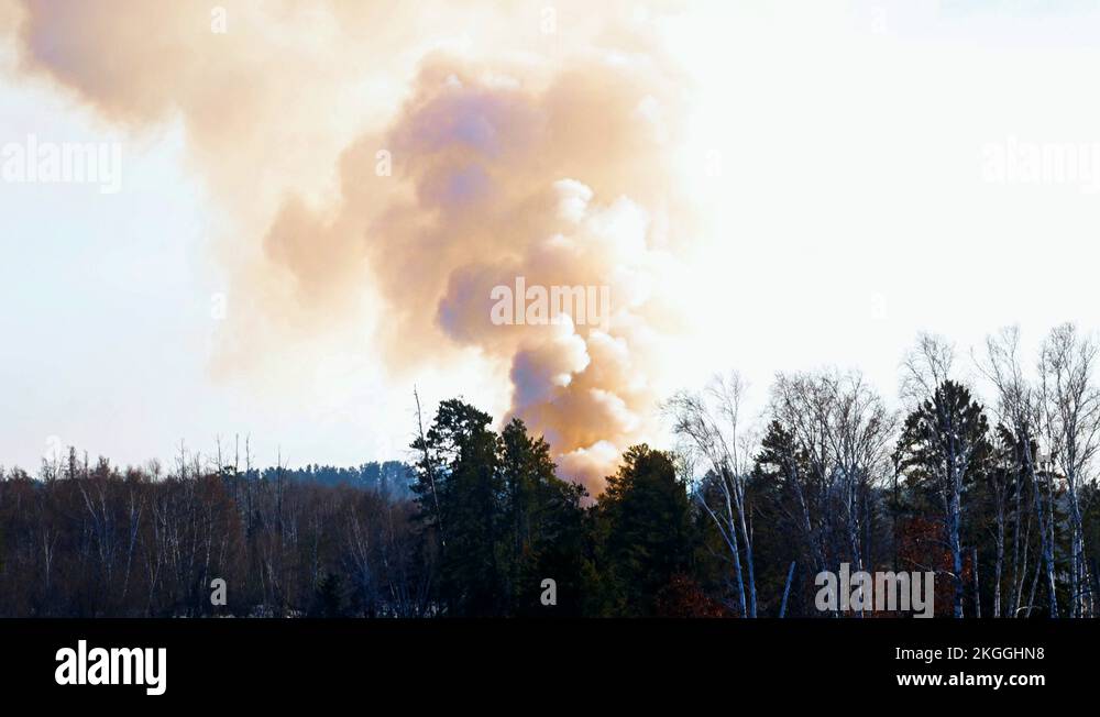 Smoke billowing from a controlled fire at a landfill site in winter ...