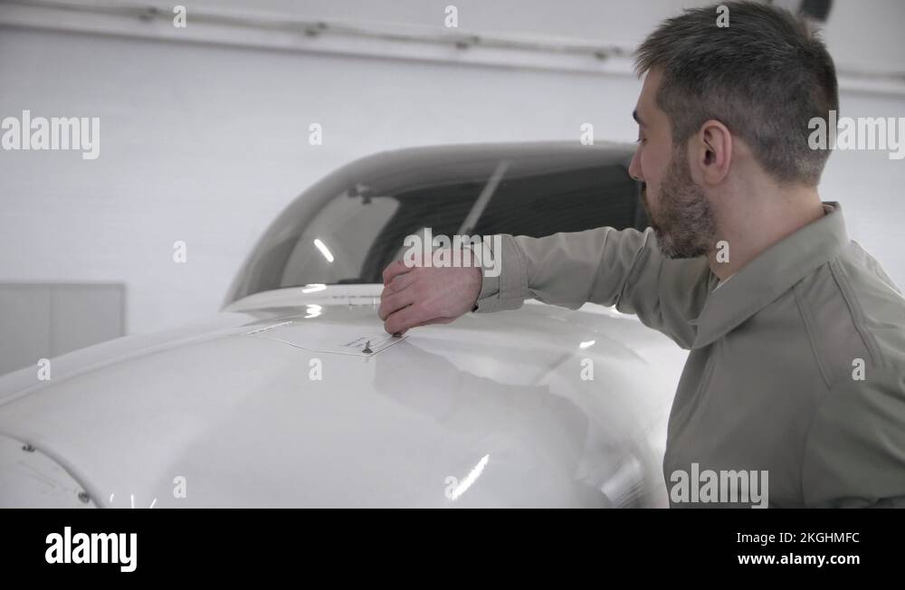 Pilot opening fuel tank of aircraft Stock Video Footage Alamy