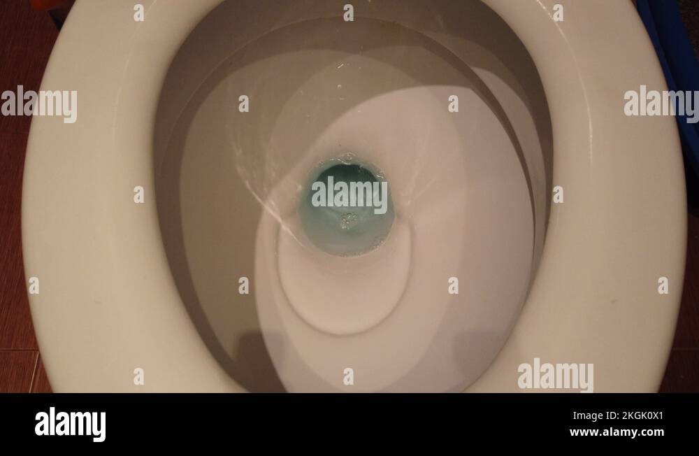 Water empties from a clean white toilet with complete flushing sequence Stock Video Footage Alamy