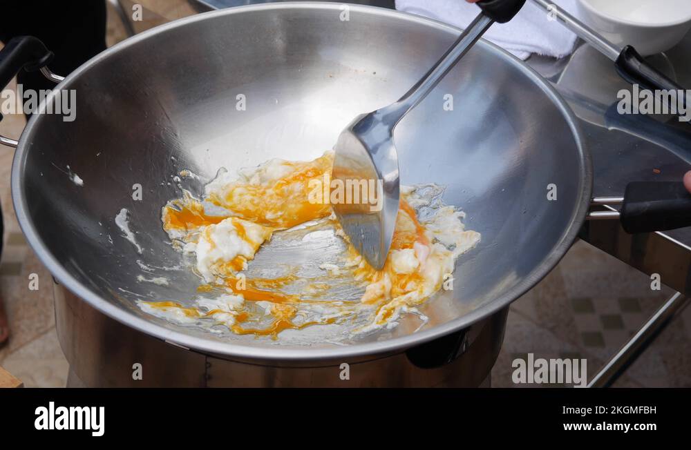 Cooking eggs in a wok. Step by step cooking pad thai. Thai cuisine