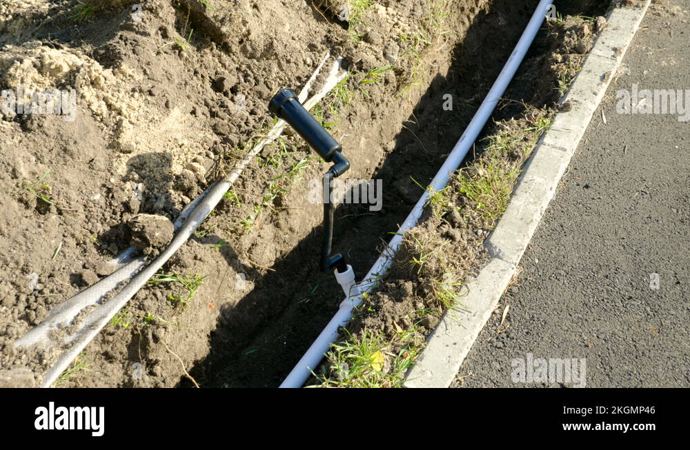 Making of automatic system for watering plants and lawn in the garden. 4K Stock Video Footage