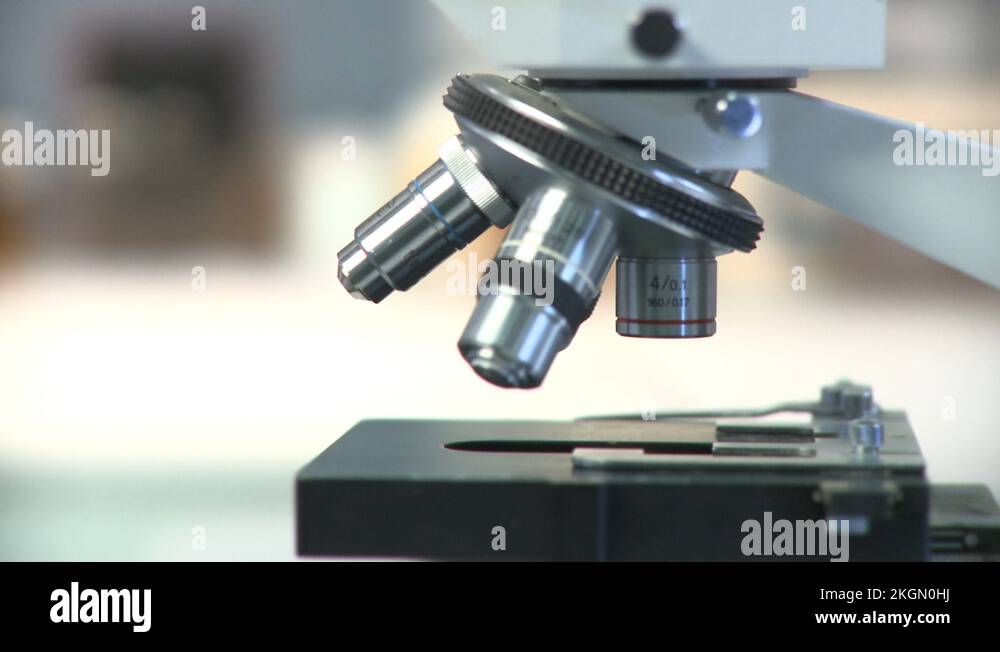 Lockdown, CU, Lab technician's hand placing slide under objectives lens