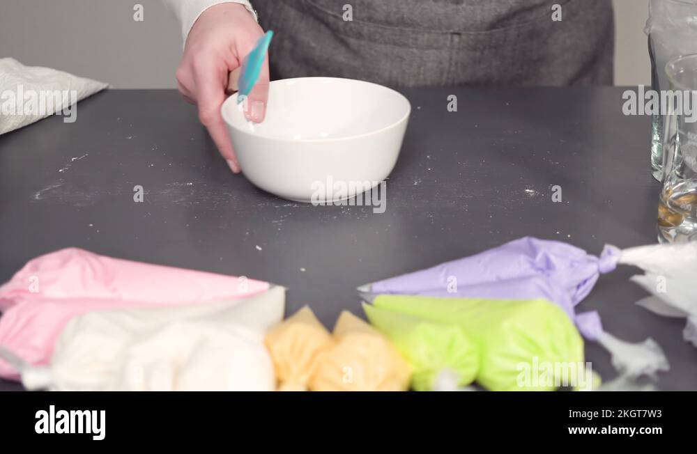Mixing in food coloring into the royal icing to decorate sugar cookies