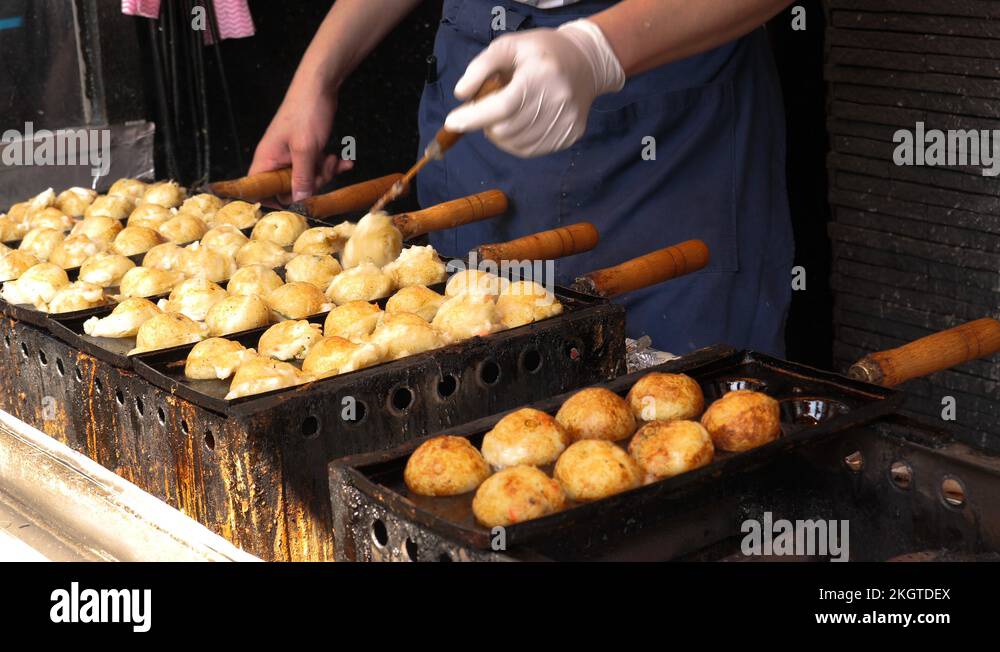 Chef preparing Takoyaki, one of the most famous Japanese street food