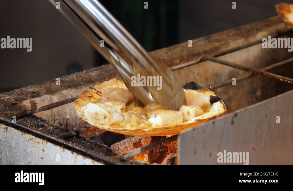 Grilled scallop on a charcoal grill. Shot in 4K Stock Video Footage Alamy