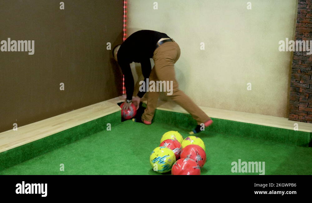 Two men playing billiards, hitting balls into holes on a floor billiard table 4K Stock Video