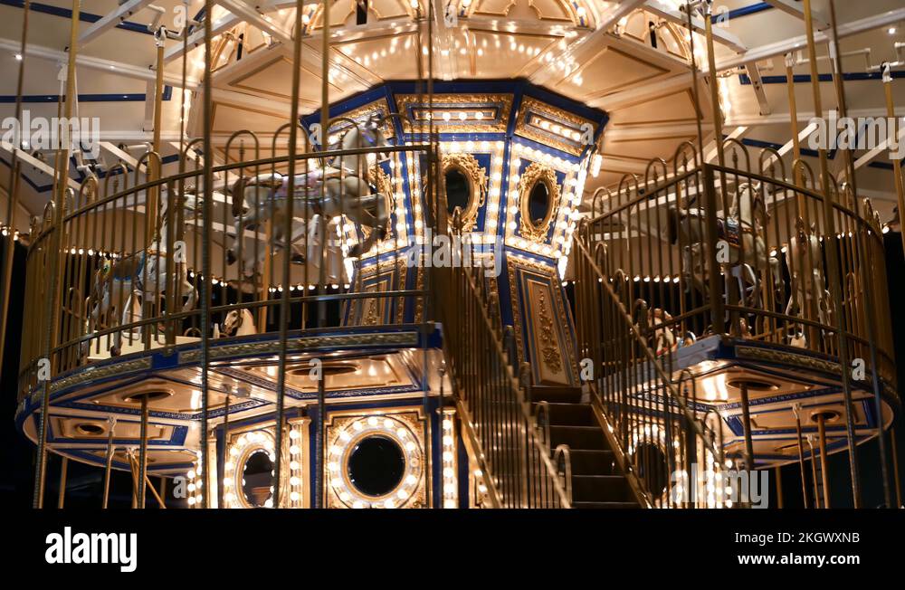 Illuminated merry go round in park. Brightly illuminated roundabout