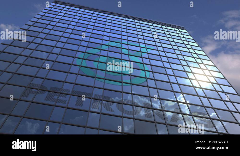 Logo of PETRONAS on a media facade with reflecting cloudy sky ...