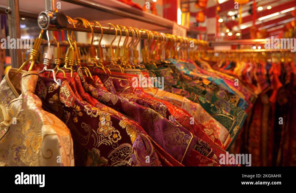 4K Traditional Chinese dress hanging on rack at night market, Zoom in ...