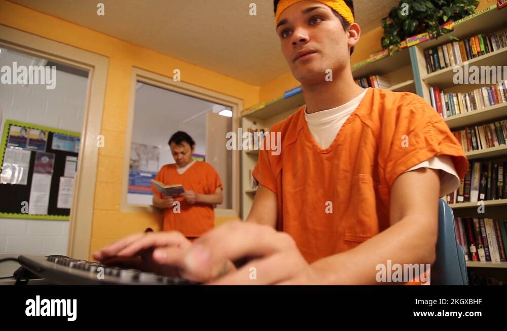 Transgender woman inmate typing on keyboard at Cibola County Detention