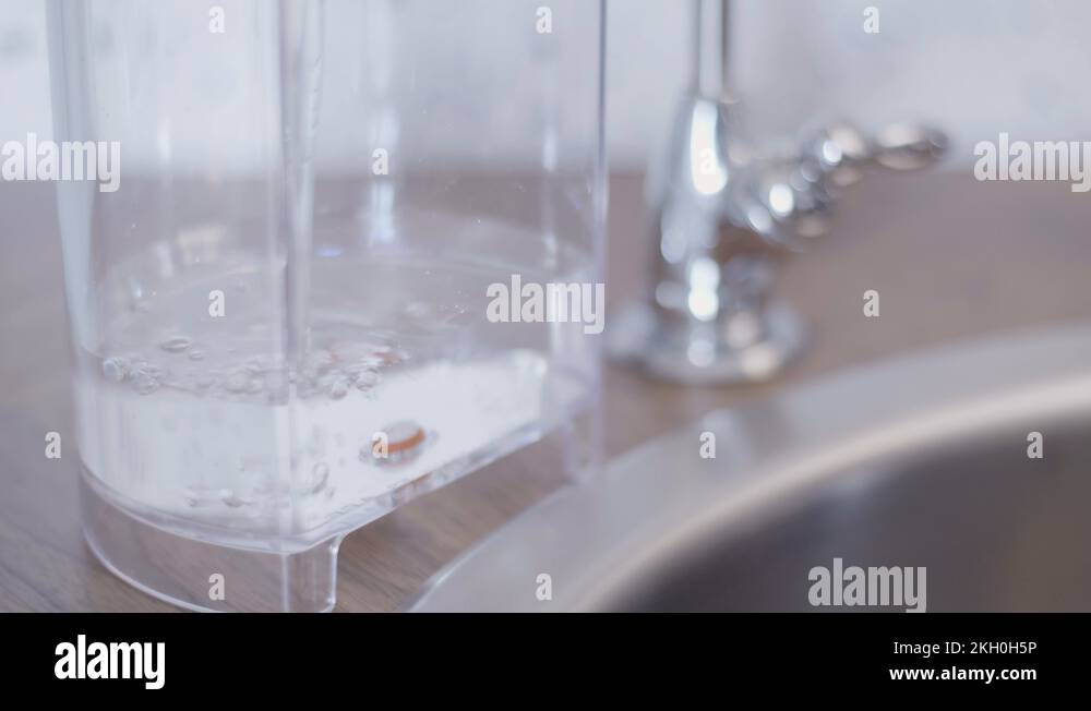 Process of rectangular plastic water tank being filled with tap water