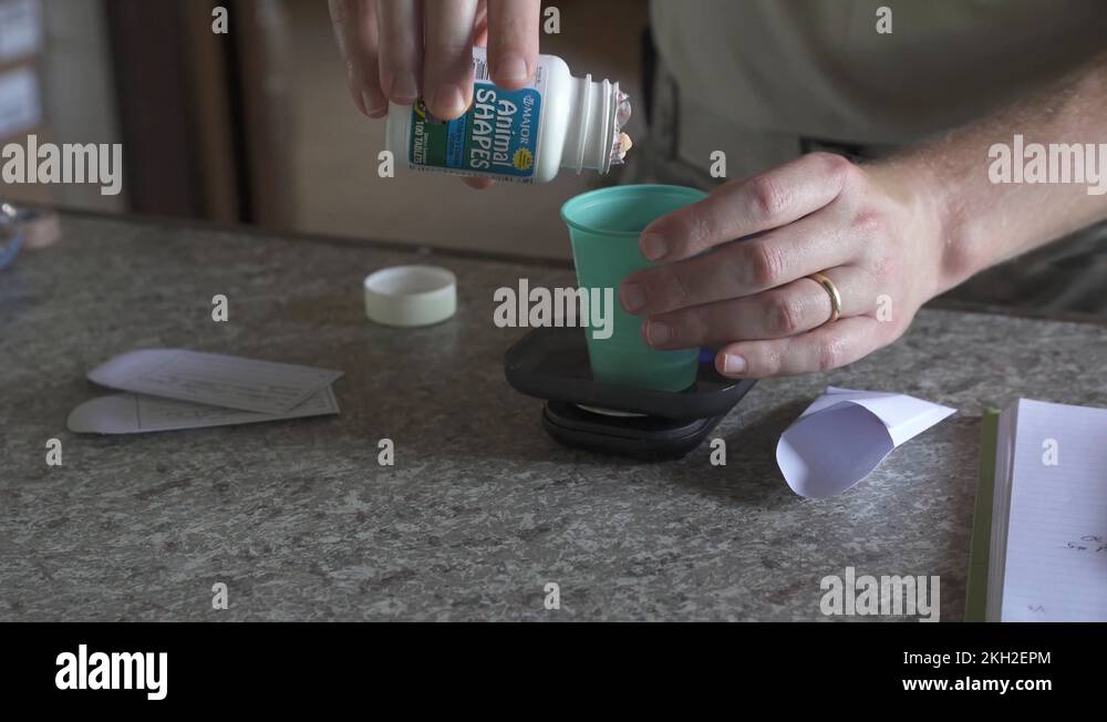 Military medic dispensing tablets from bottle into cup Stock Video