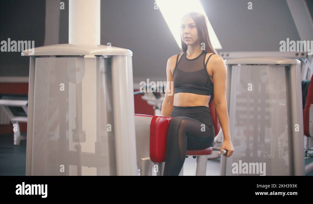 An athlete woman with long hair training in the gym exercising on the