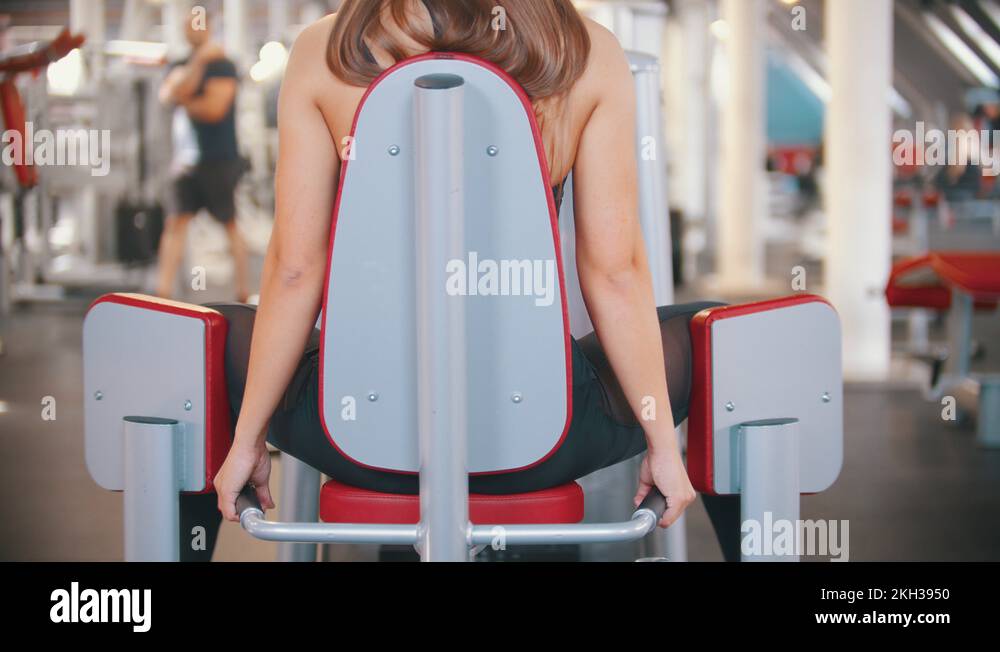 An athlete woman with long hair training in the gym exercising on the