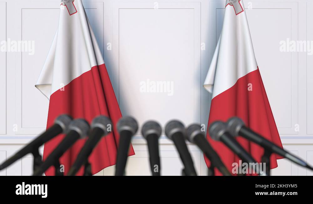 Maltese official press conference. Flags of Malta and microphones