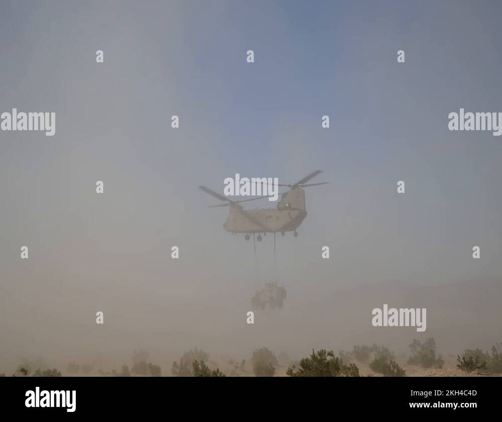 CH-47 Chinook conduction sling load operations in dust storm Stock ...