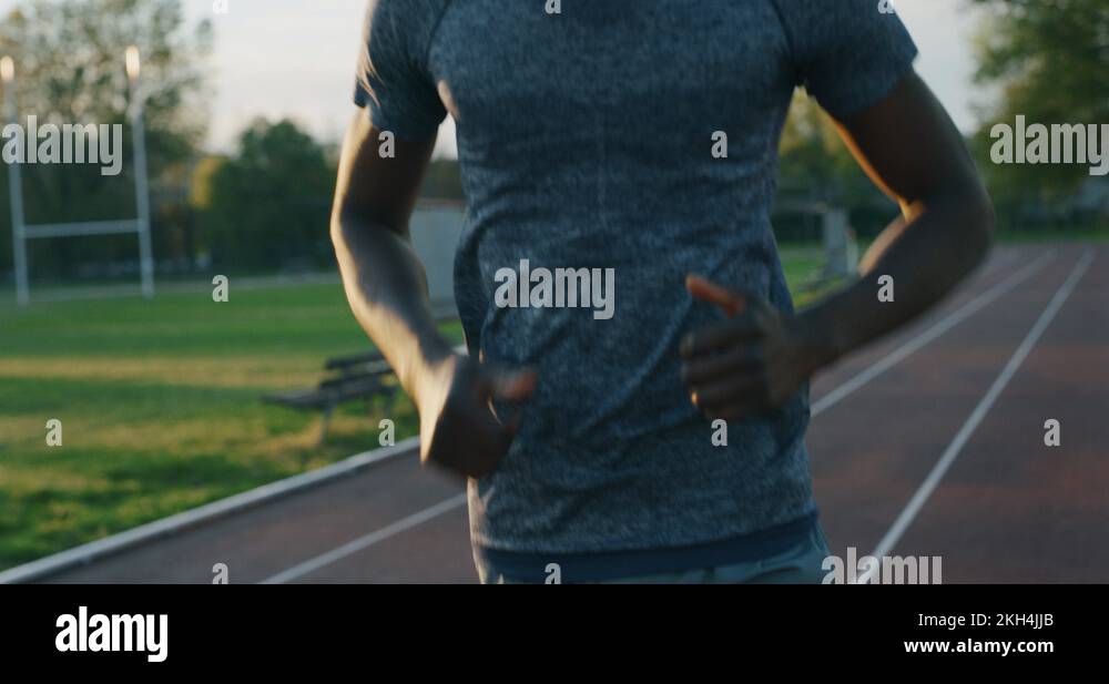 Slow motion of young african male athlete is running on race track in ...