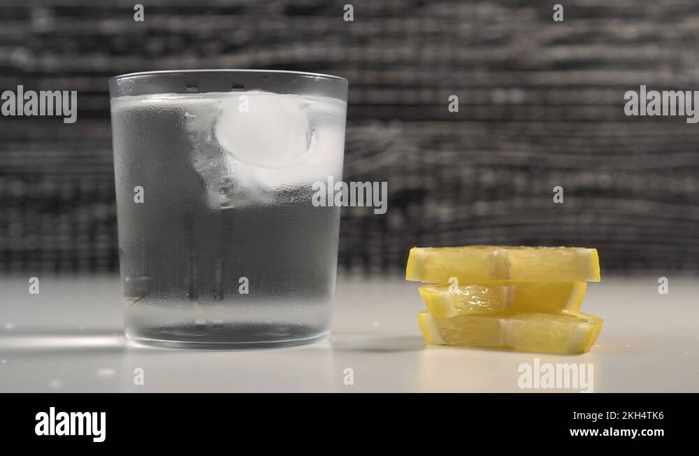 A tube of water and ice in a steamed glass on a black and white