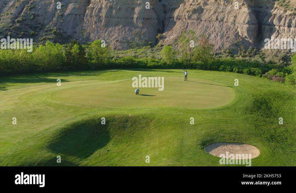 Two Golfers on Putting Green, Bully Pulpit Golf Course in North Dakota