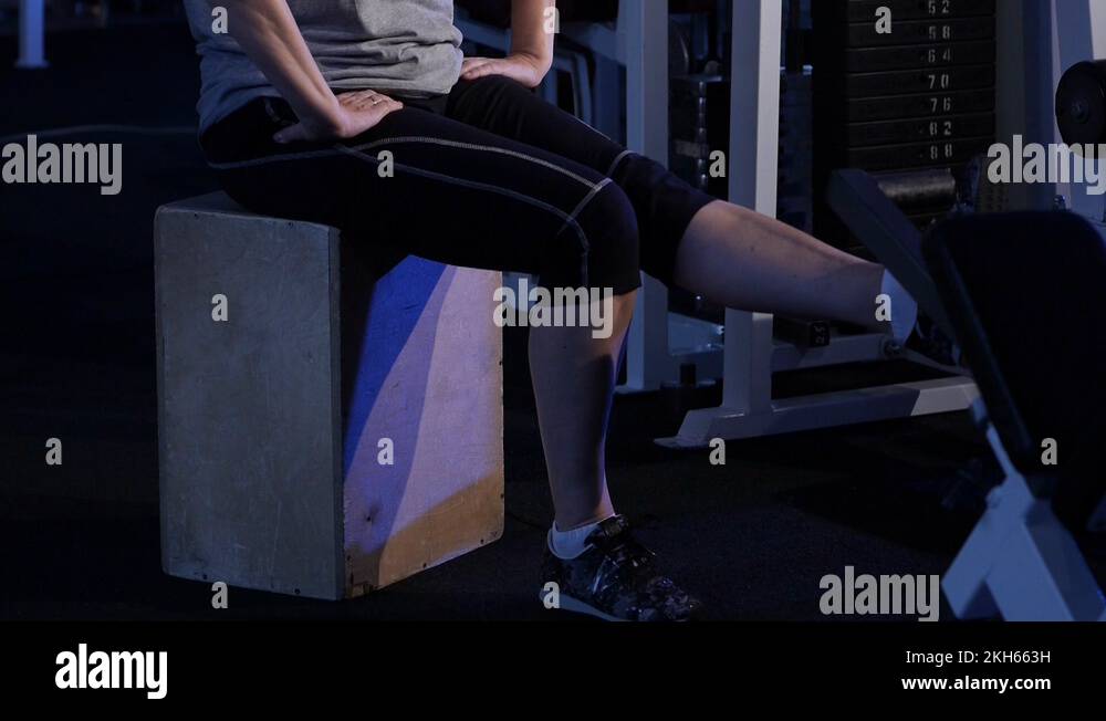 Extension of the legs at the knees in a sitting position.An older woman