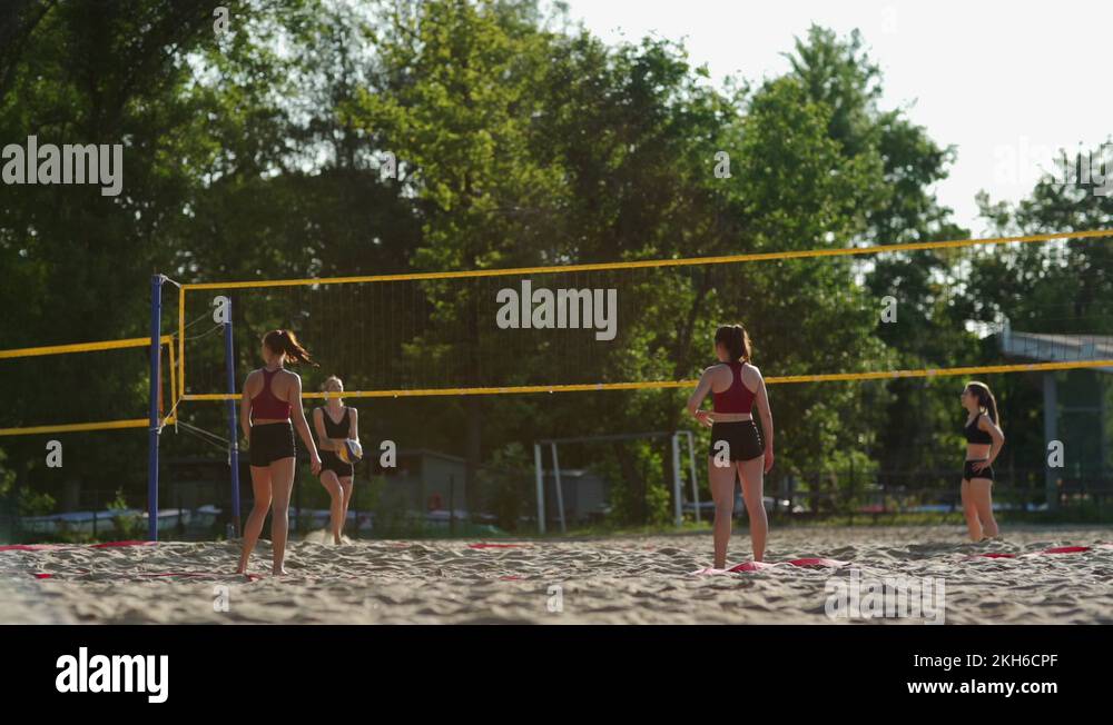 Barefoot girls playing beach volleyball Stock Video Footage Alamy