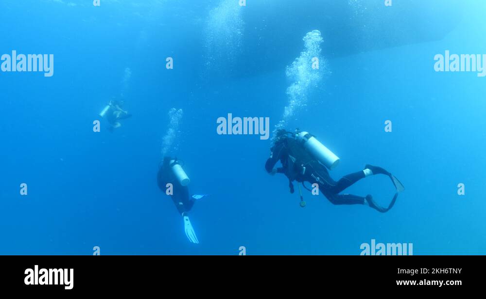 boat scenery underwater sun rays and beams scuba divers to dive