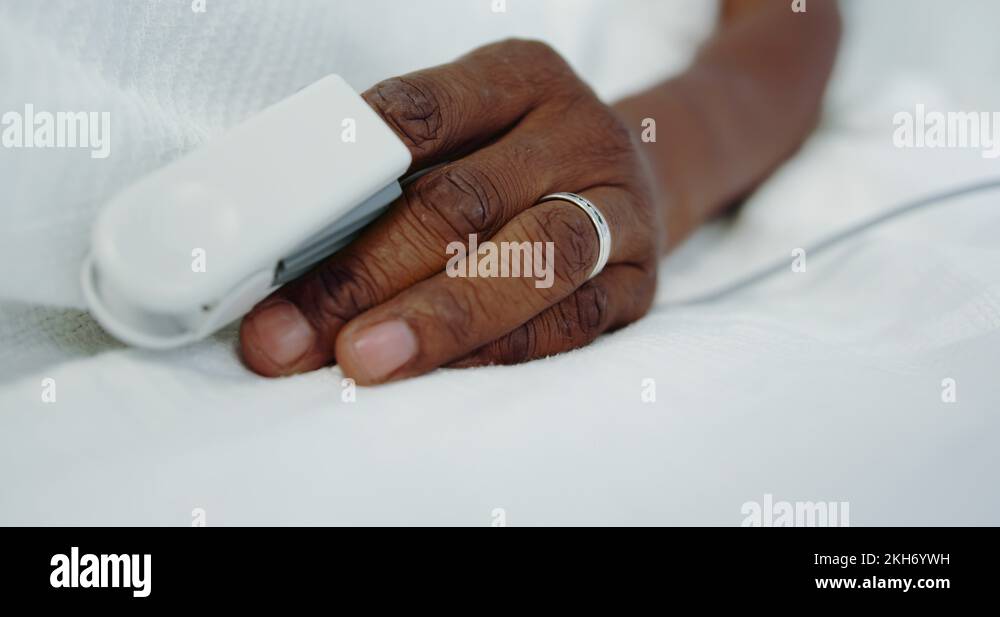 Closeup of pulse oximetry on African american male patient hand in the