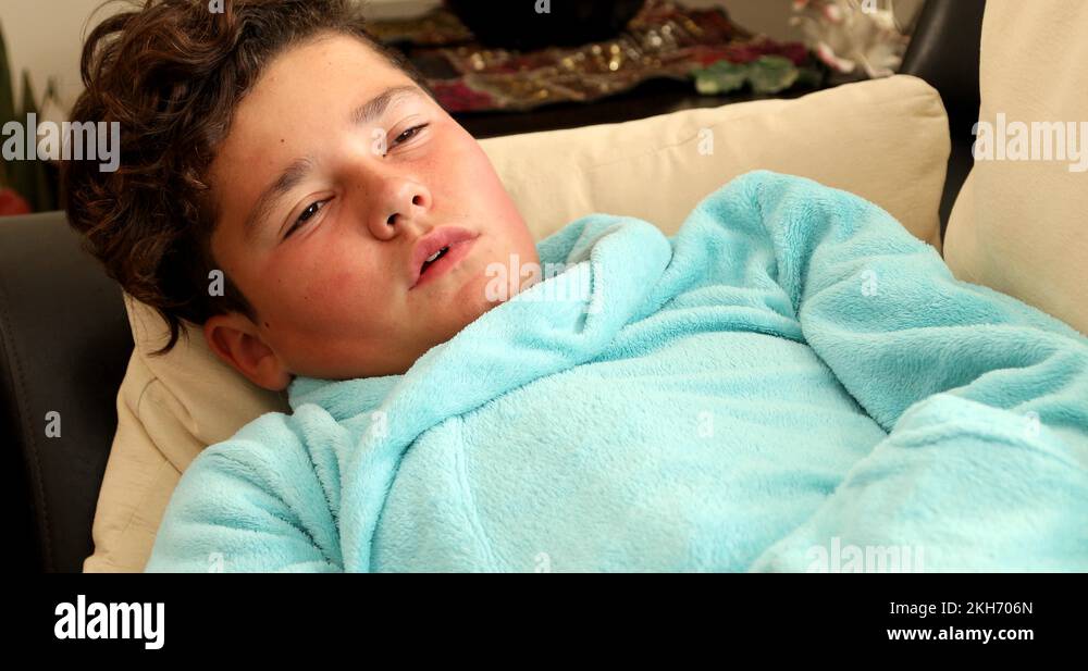 Young boy having a sore throat lying on a bed Stock Video Footage Alamy