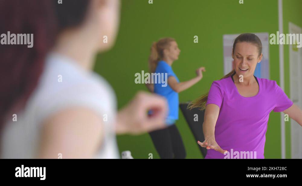 Female fitness instructor shows how to do exercise in a correct way ...