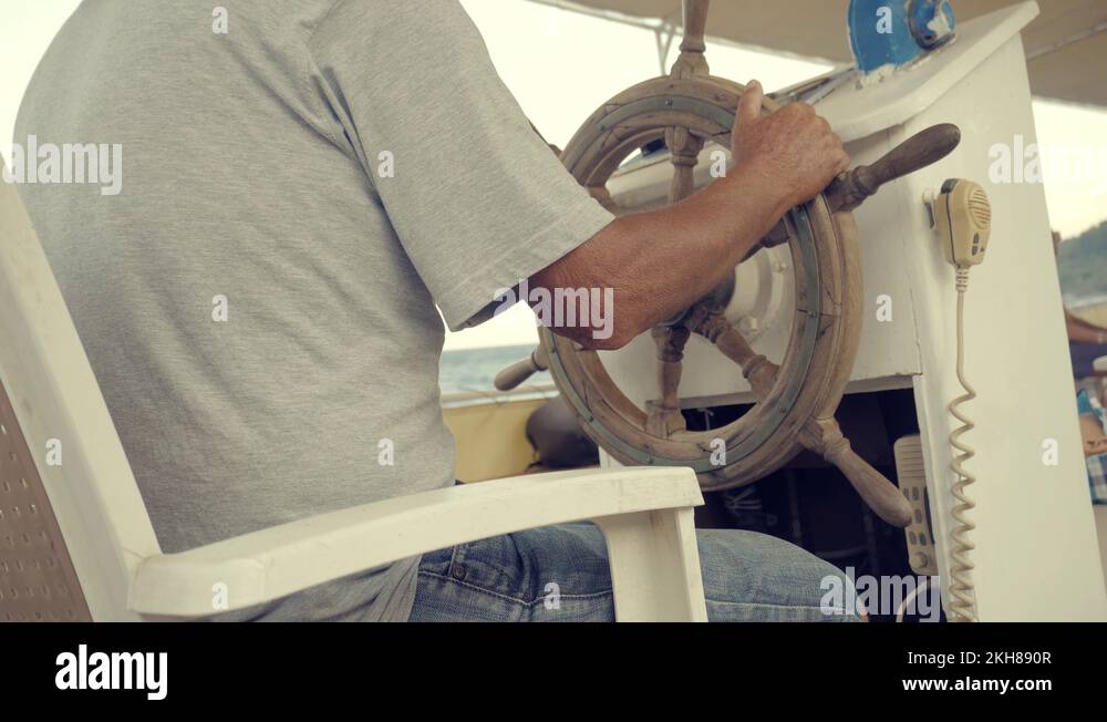 Steering Wheel On Pleasure Boat.Captain Turns Wooden Steering Wheel On