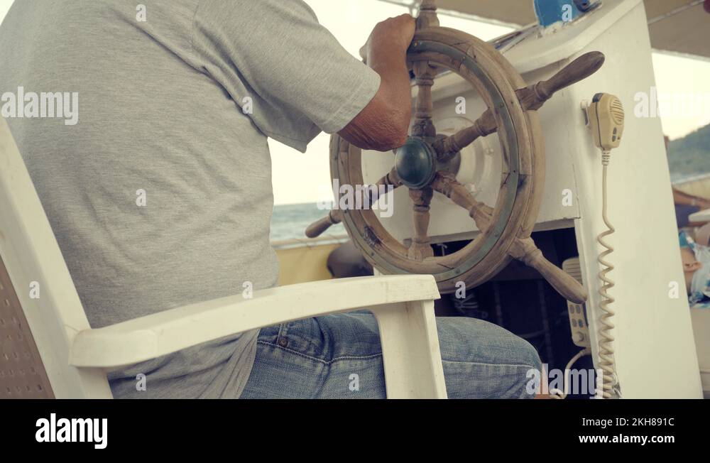 Steering Wheel On Pleasure Boat.Captain Turns Wooden Steering Wheel On
