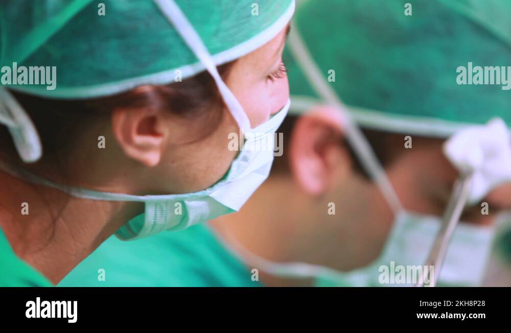 Nurse mopping the brow of a surgeon Stock Video Footage Alamy