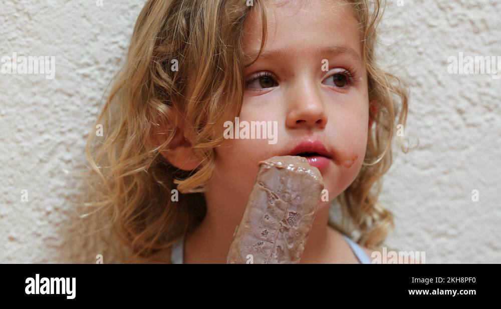 Cute adorable little girl eating chocolate icecream snack Stock Video