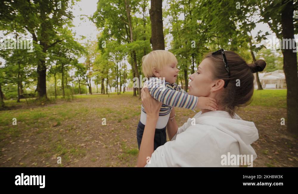 Happy mom holds in her arms and then throws her son up Stock Video