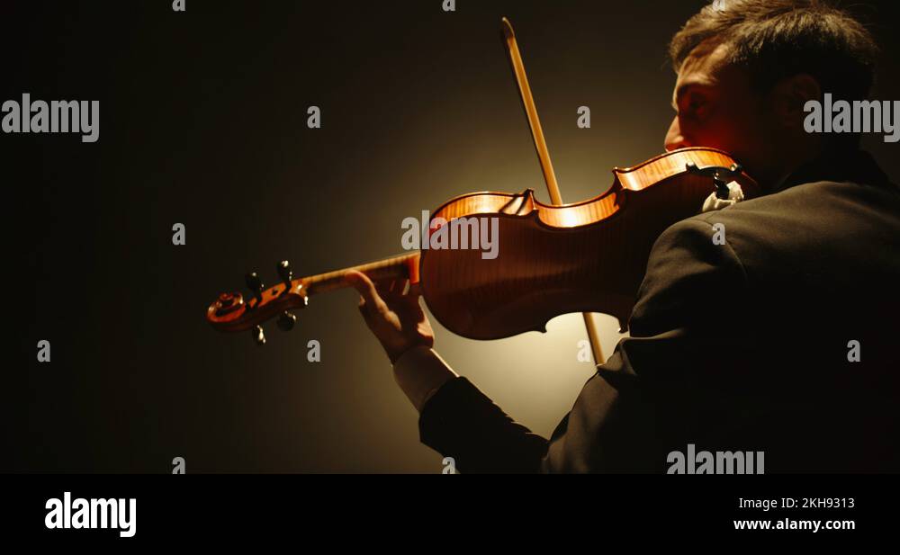 Male violin player having a solo on stage. Professional musician