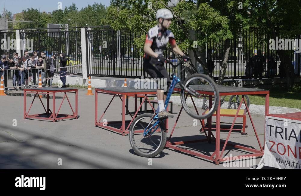 Jumping on trampoline with bike, extreme sports at slow motion Stock