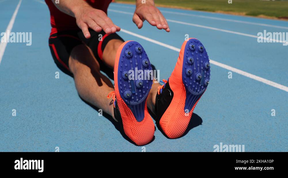 Stretch exercise fit athlete man stretching leg muscles on track and