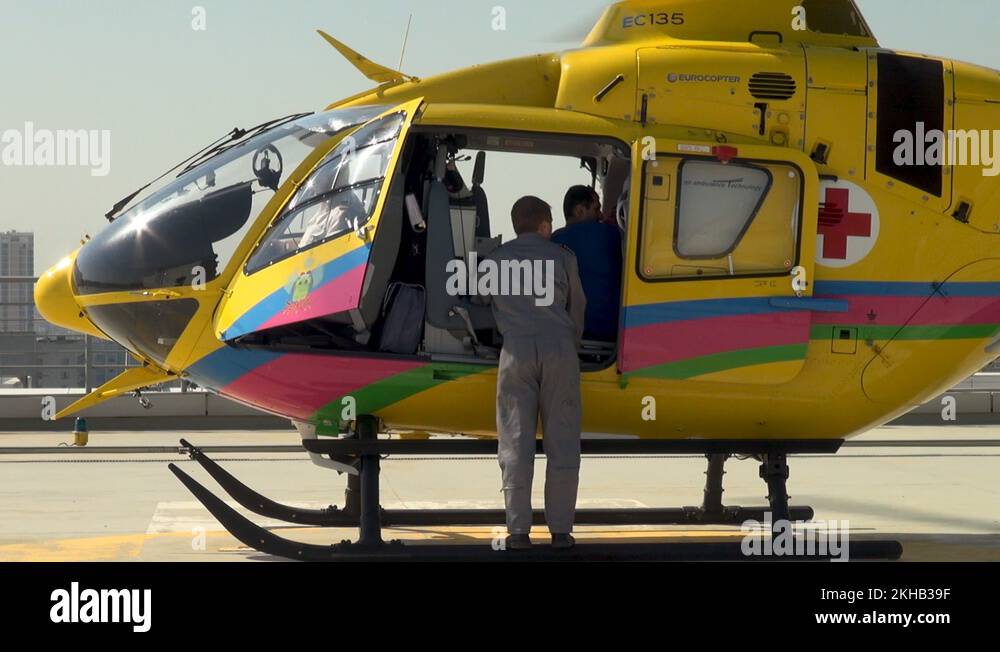 EC135 medical helicopter on roof hospital building with rotating blades ...