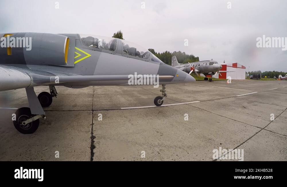 Military jet plane rides along the landing strip of the old airfield ...
