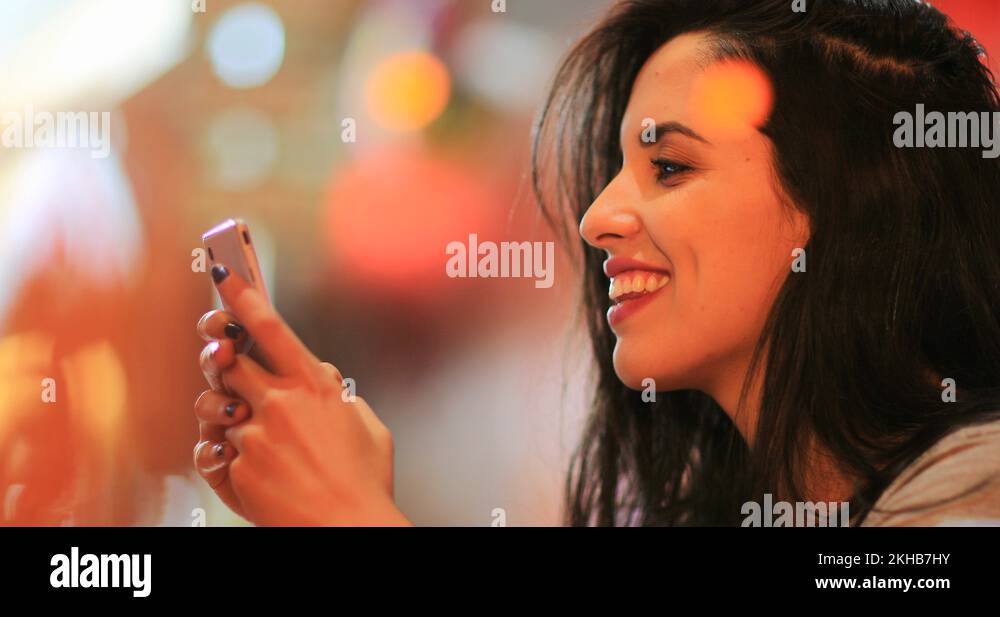 Candid surprise reaction of girl in front of cellphone reading text