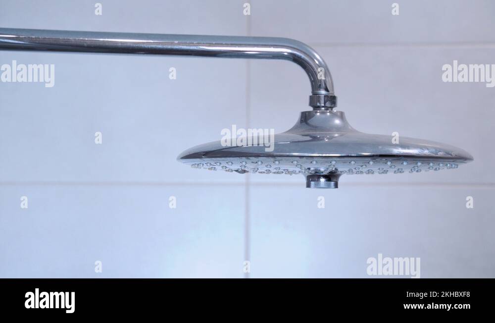 Water running from shower head and faucet in modern bathroom. Rain