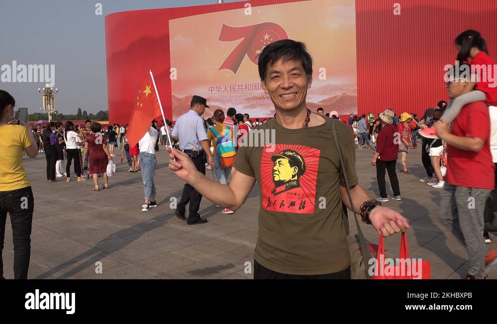 China nationalism patriotism smiling man wears Mao Zedong shirt Stock