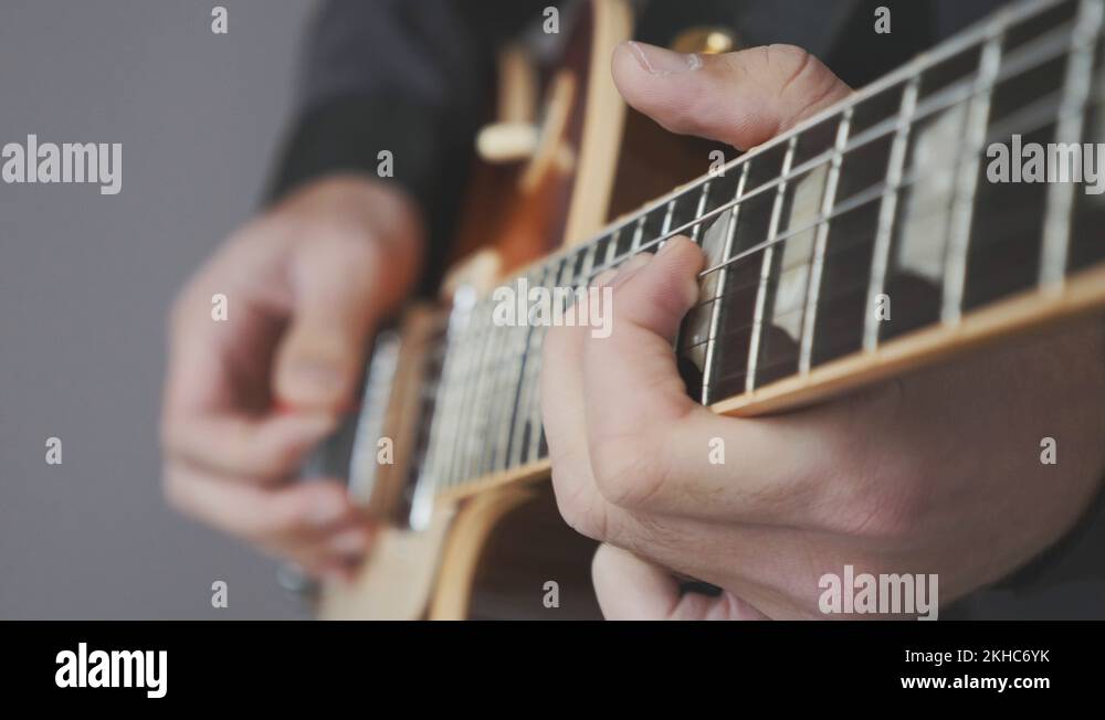 Male hands playing on electric guitar close up. Fingers on guitar fretboard Stock Video Footage