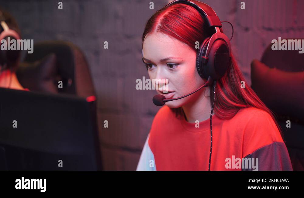 Young girl gamer in headphones, plays a video game, cyber sportsman at