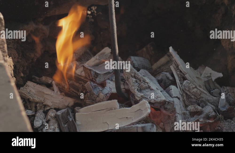 Yixing clay pot for tea is firing in a fire. burning a clay teapot in a