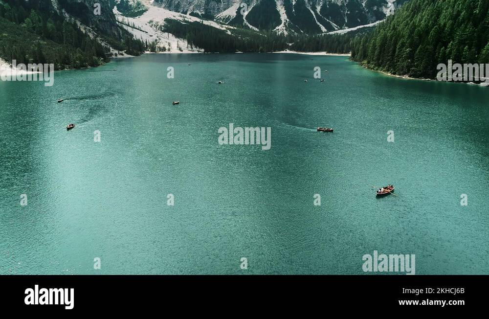 Rowing boats floating on a famous alpine lake Lago di Braies. Tourism ...