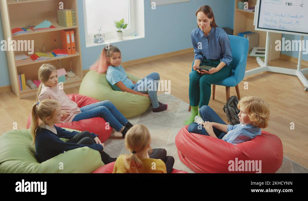 School Class: Children Sitting on Bean Bags while Teacher Explains ...