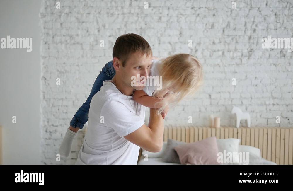 Happy family loving dad giving a cute little funny baby daughter